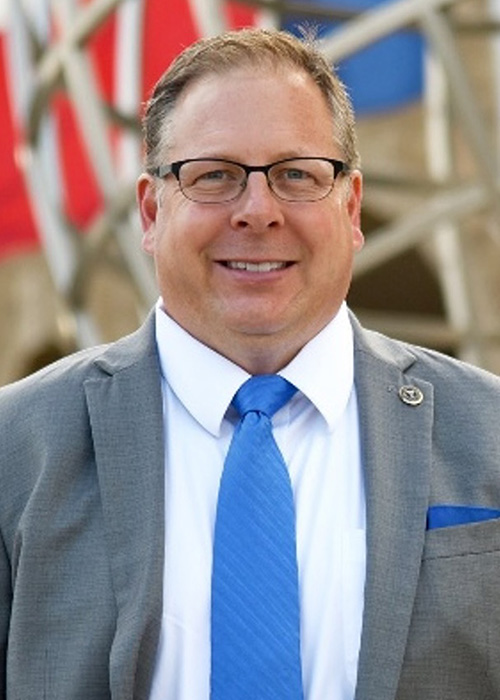 An image of a professor in formal attire