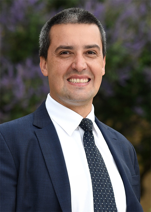 An image of a professor in formal attire