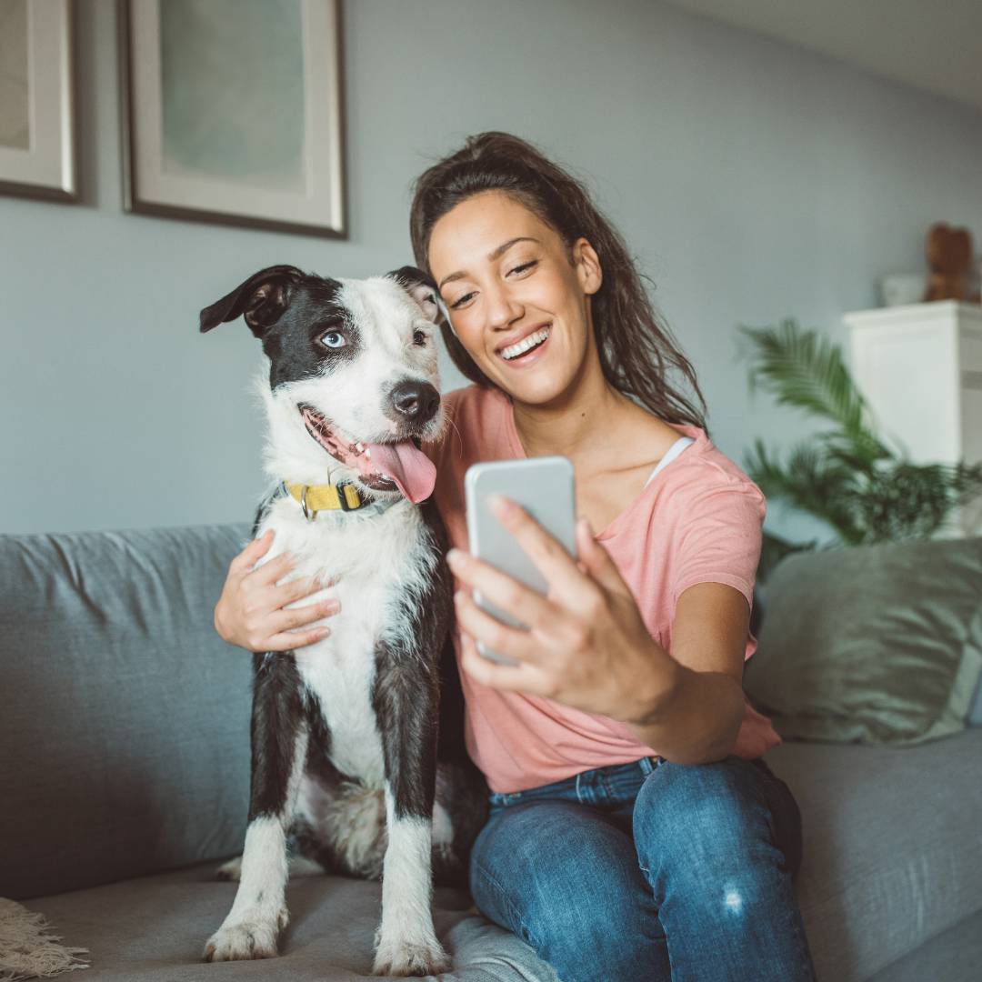 Girl takes photo with dog