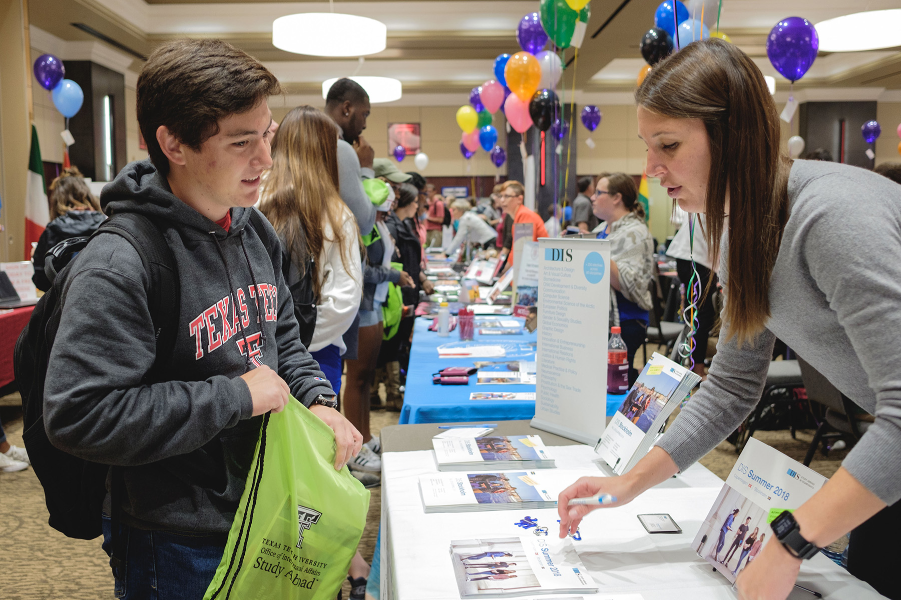 Student talking with exhibitor during Study Abroad Fair