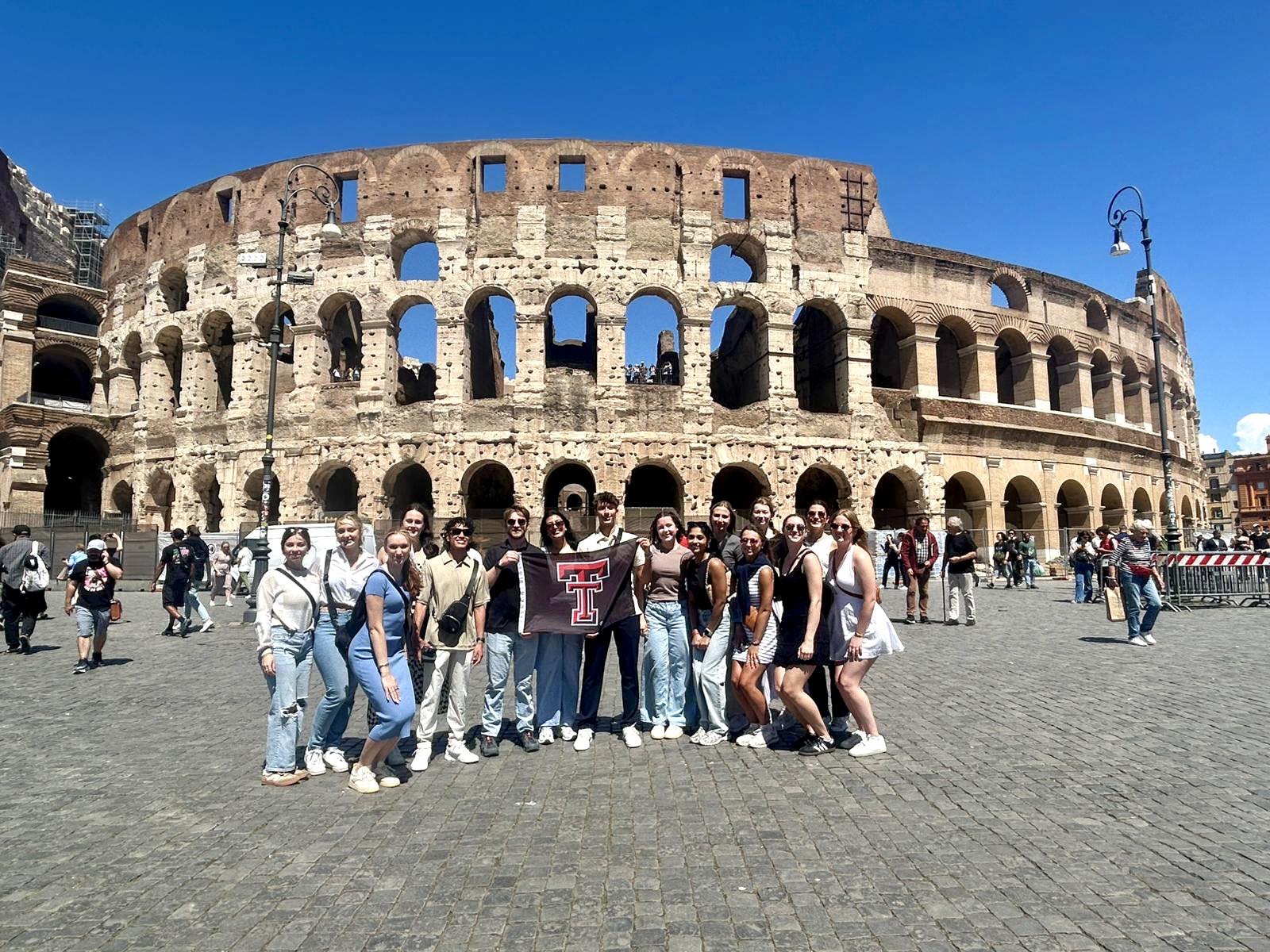 Students with TTU flag in front of Colosseum in Rome, Italy