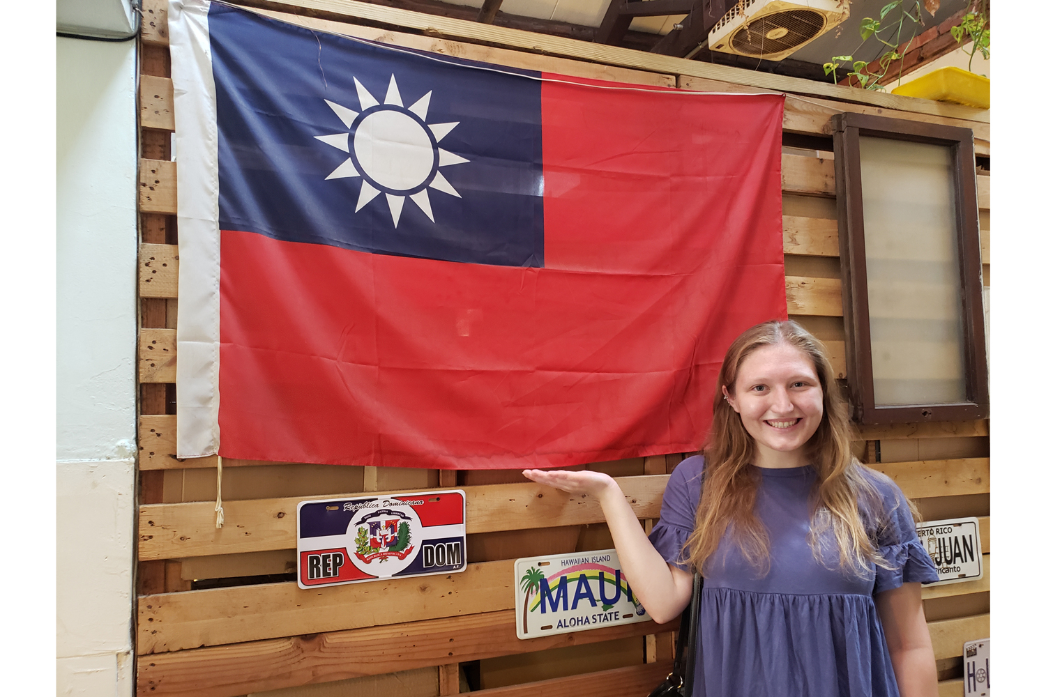 Female standing next to Taiwan flag