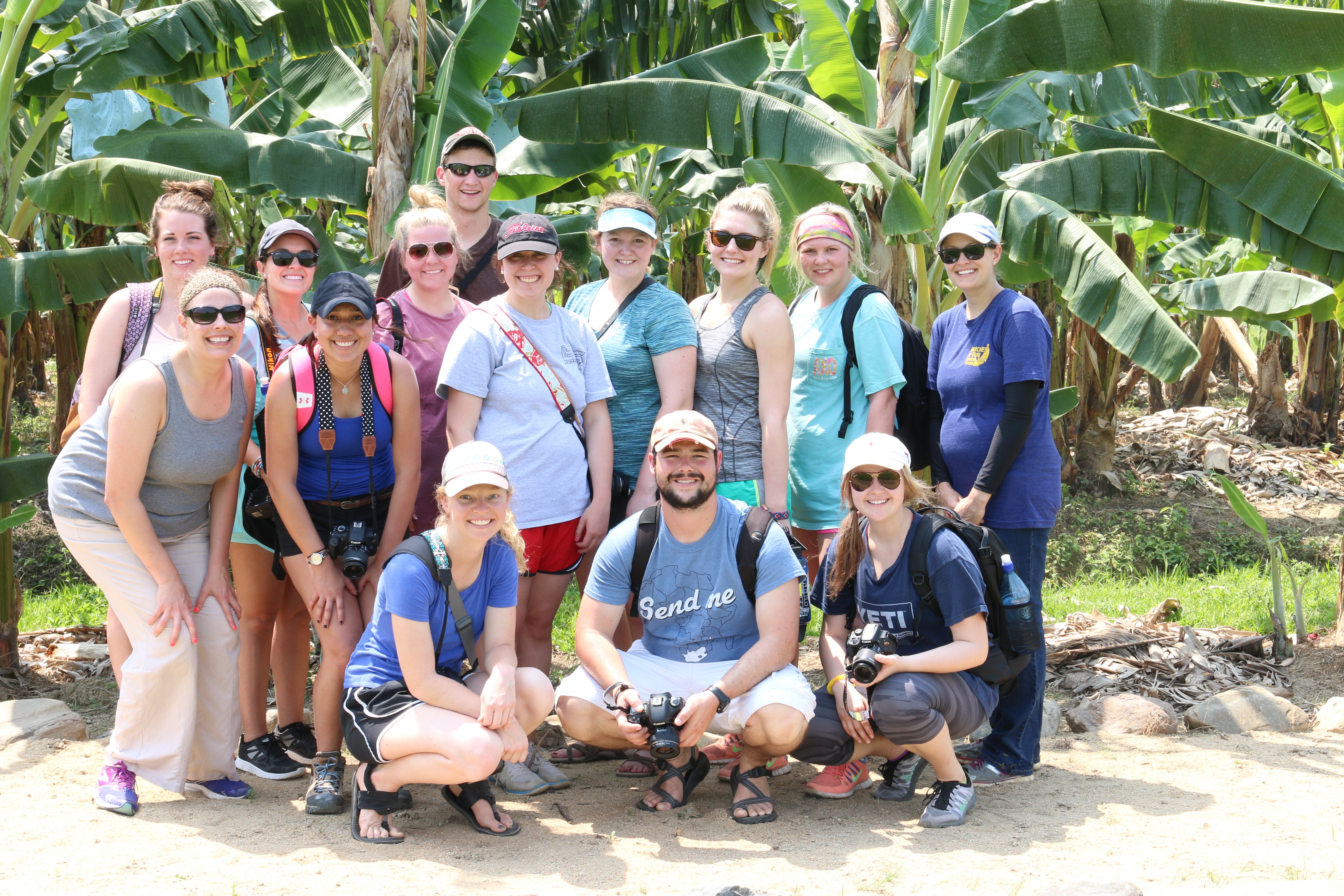 Students standing in the green foilage of Belize