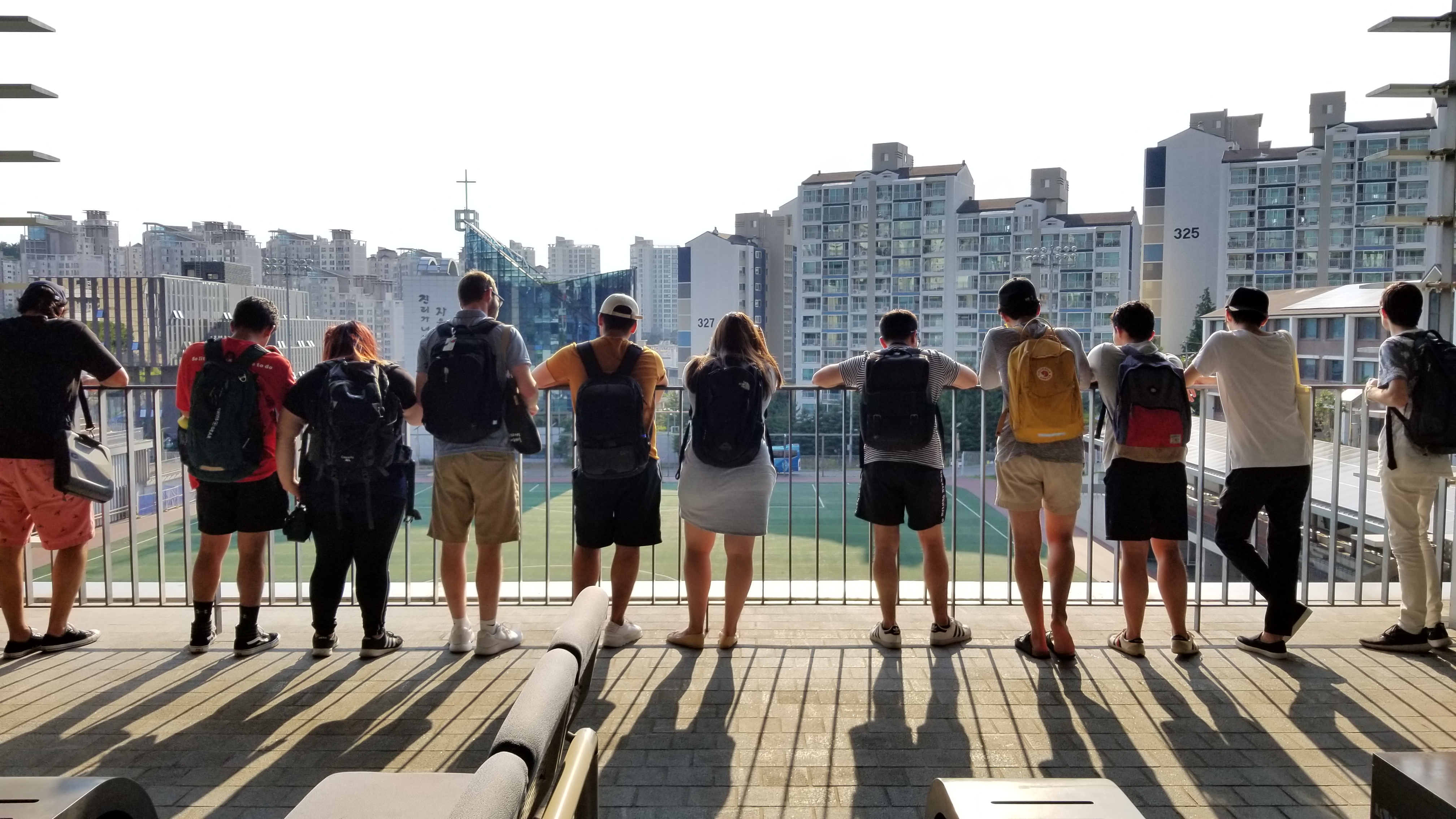 Students overlooking grassy court in South Korea.