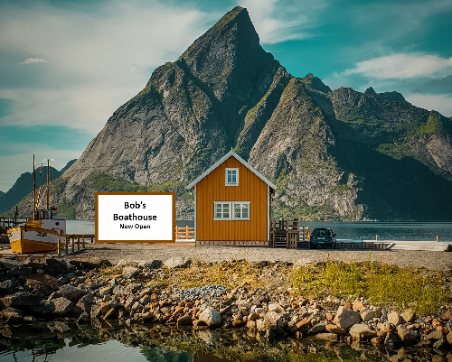 A small house sits next to a boat dock along a rocky shoreline. A large mountain towers above the house in the background. A sign next to the house says Bobs Boathouse: Now Open