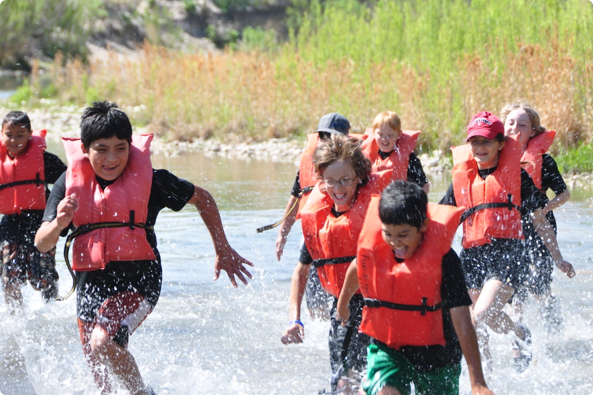 Students running in river