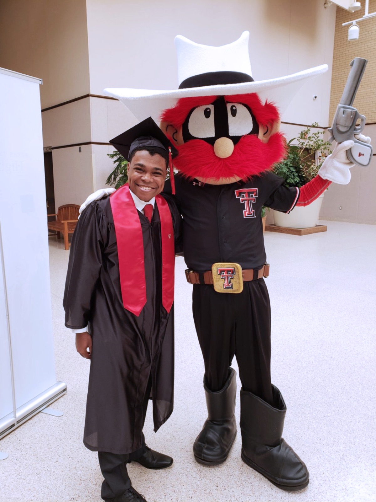 Chase poses with Texas Tech’s mascot, Raider Red. 