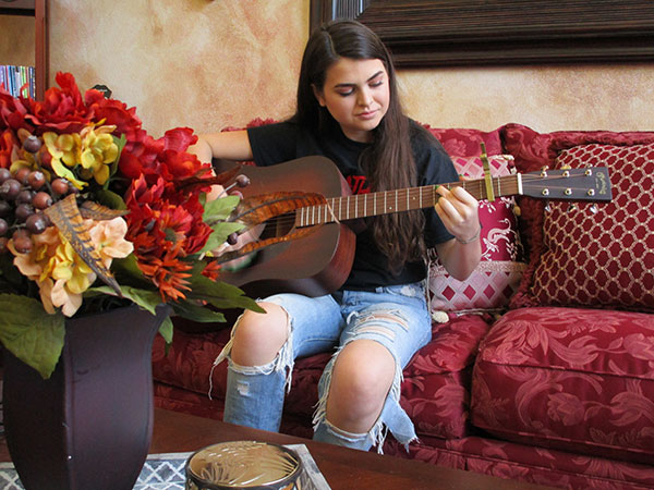 Presley playing guitar.