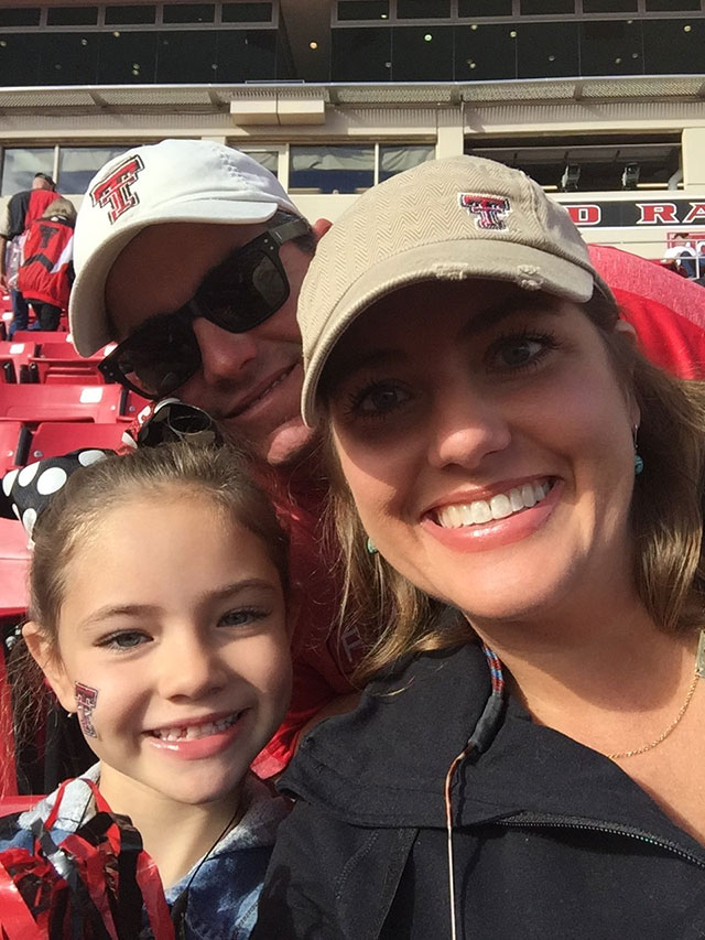 Tenlee Nyman with her parents at Jones AT&T Stadium.