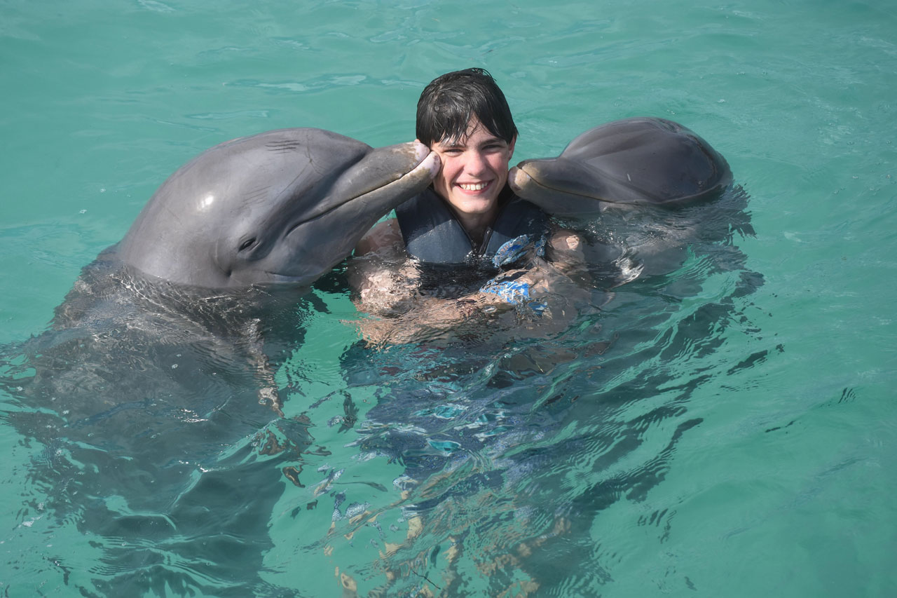 Wesley swimming with dolphins on a family trip to the Dominican Republic.
