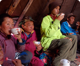 The Alexander family having reindeer milk tea with the Tsaatan.