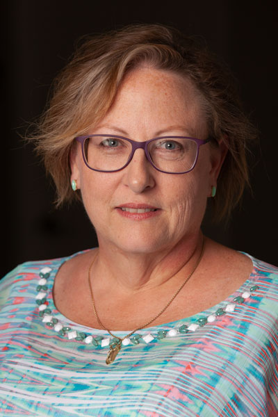 A headshot of Annette Coon smiling