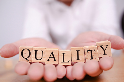 TTU K-12 boats quality online courses. A pair of hands placed together facing upwards with blocks spread across both hands that spell quality.