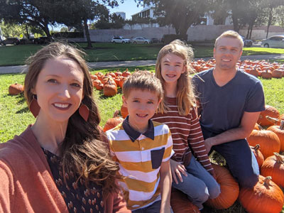 Warwick family sitting in yard with pumpkins