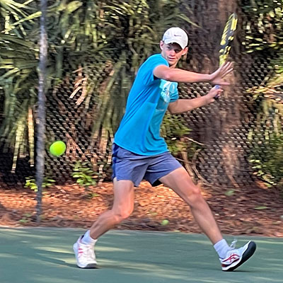 Graydon Buckingham playing tennis.