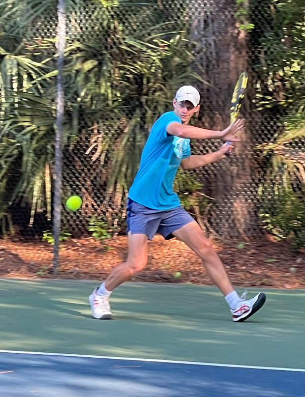 Graydon Buckingham  playing tennis.