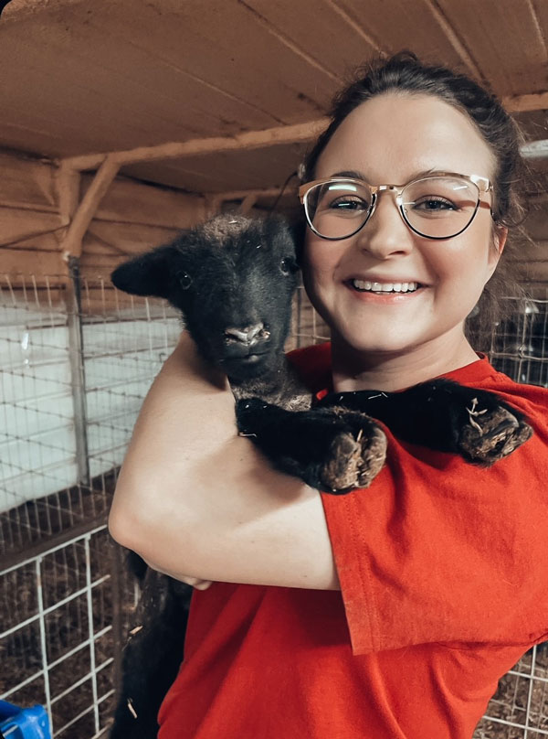 Madison Landreth holding a black lamb