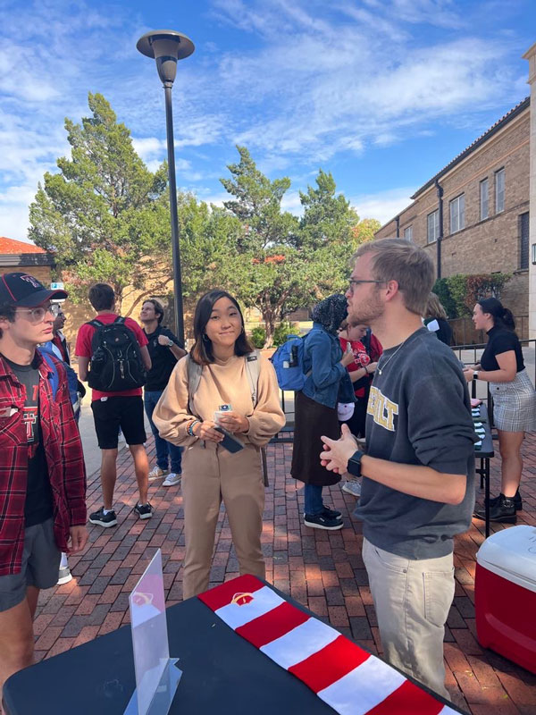 Kobe speaks to other students outside the Honors College at Texas Tech University.