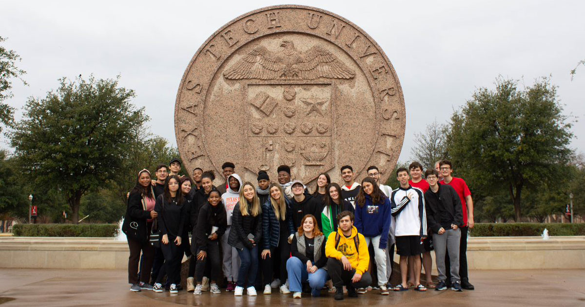 TTU K-12 Winter Camp attendees in front of the Texas Tech University seal on the Lubbock campus.