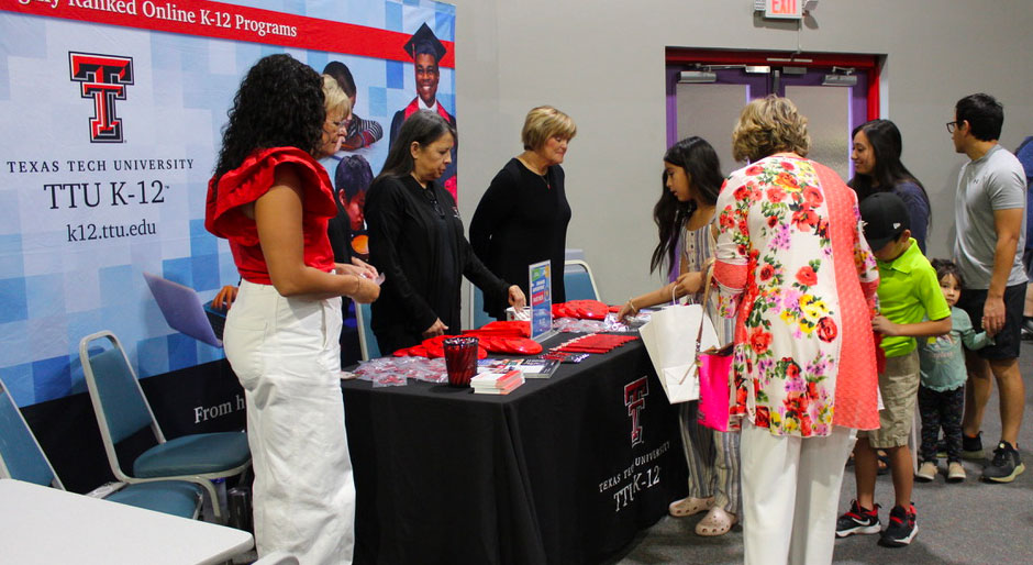 TTU K-12 staff distribute information from their booth.