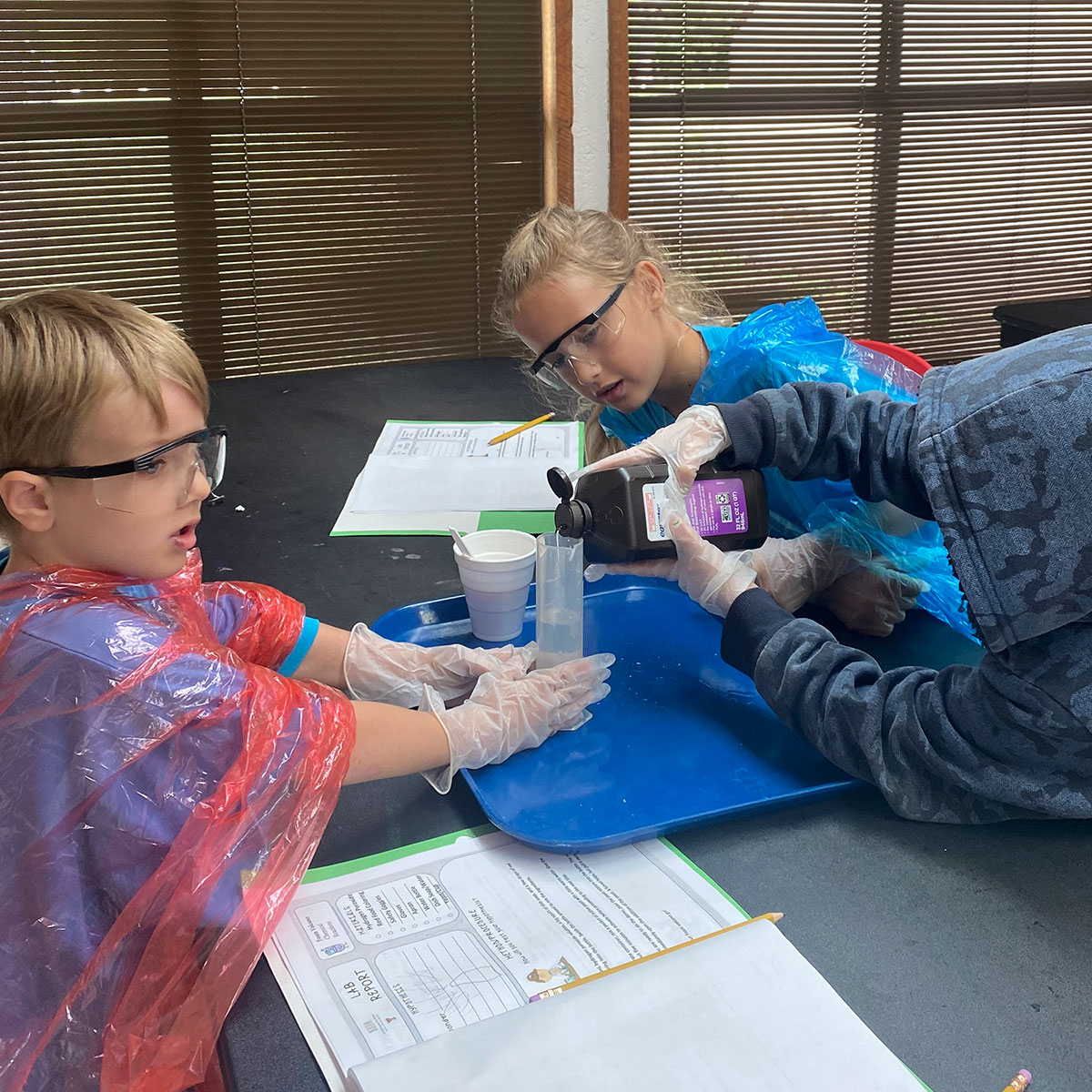 Students in Brett Mosley's class prepare ingredients for chemical reactions