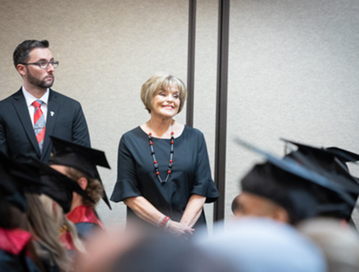 Brenda watches cheerfully as she watches the Texas Tech High School 2023 commencement.