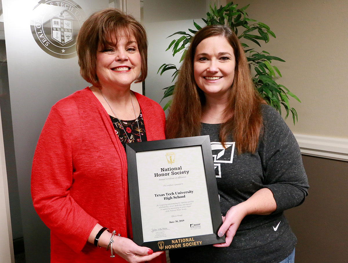 Brenda Shupe and Cari Moye show off the charter certificate for the NHS program.