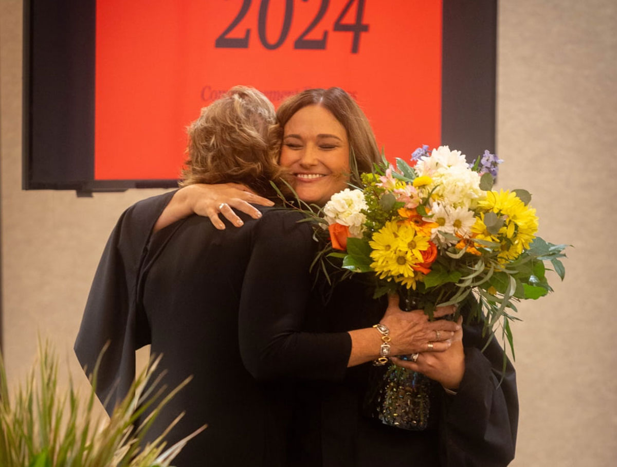 Principal Cari Moye hugs Brenda