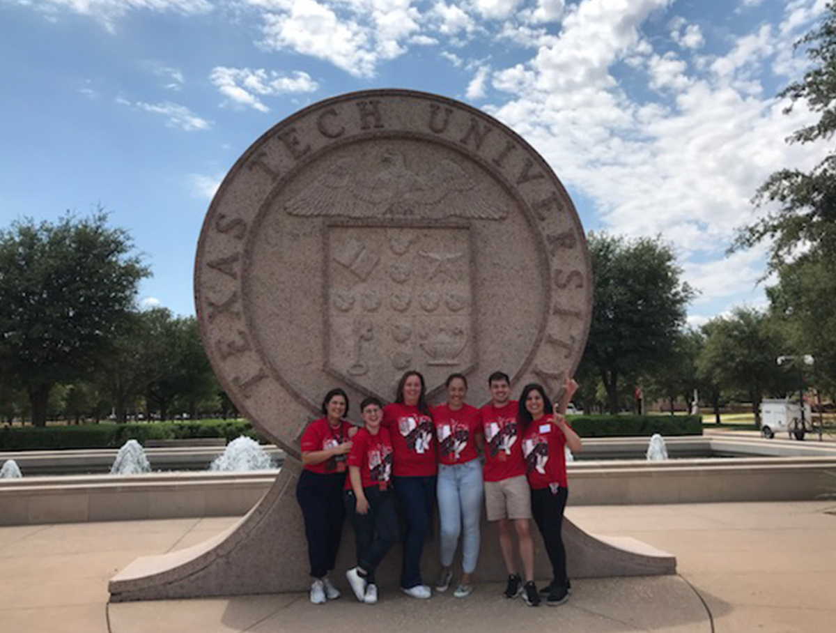Brazil school leaders in front of Texas Tech seal