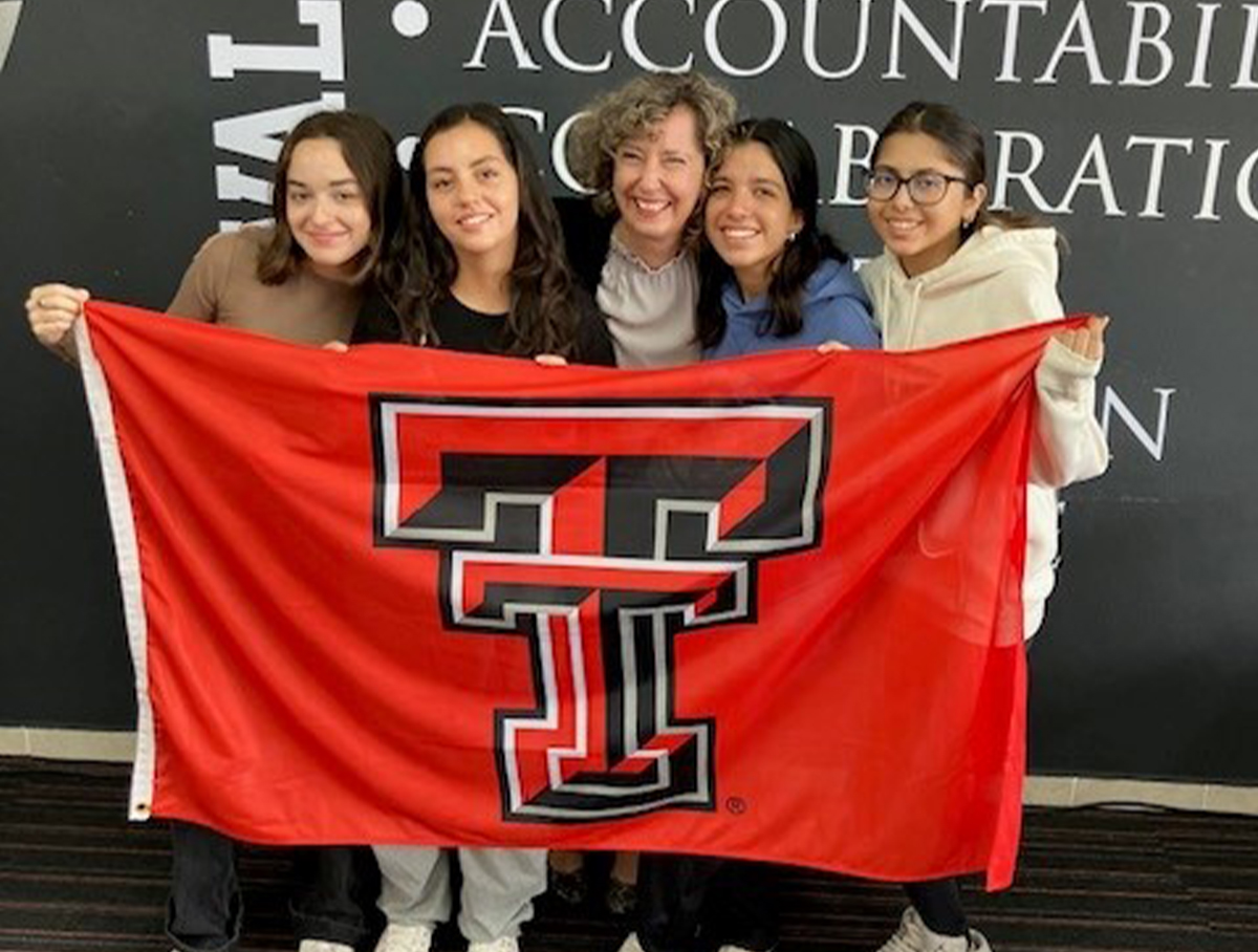 Claudia Boy Loecken, center, program coordinator for Césare, celebrates with her graduates