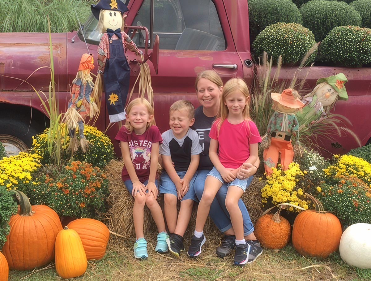 Sarah with her family at a pumpkin patch.