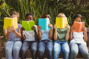 A group of children reading books.