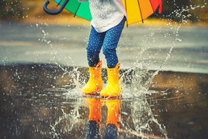 Rain splashing up from a child’s boots.