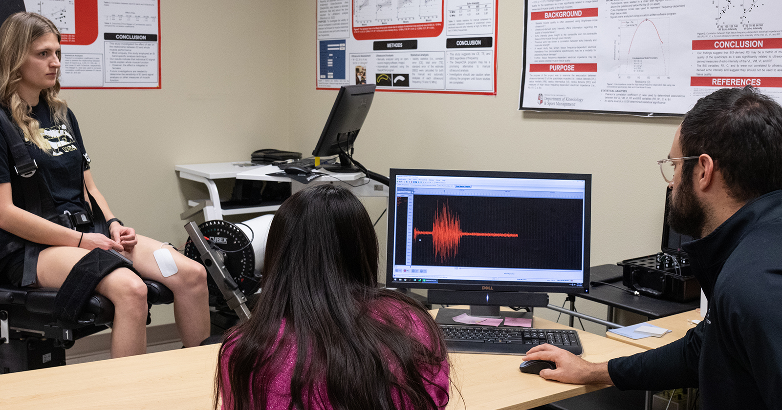 About Kinesiology lab with people looking at results on computer