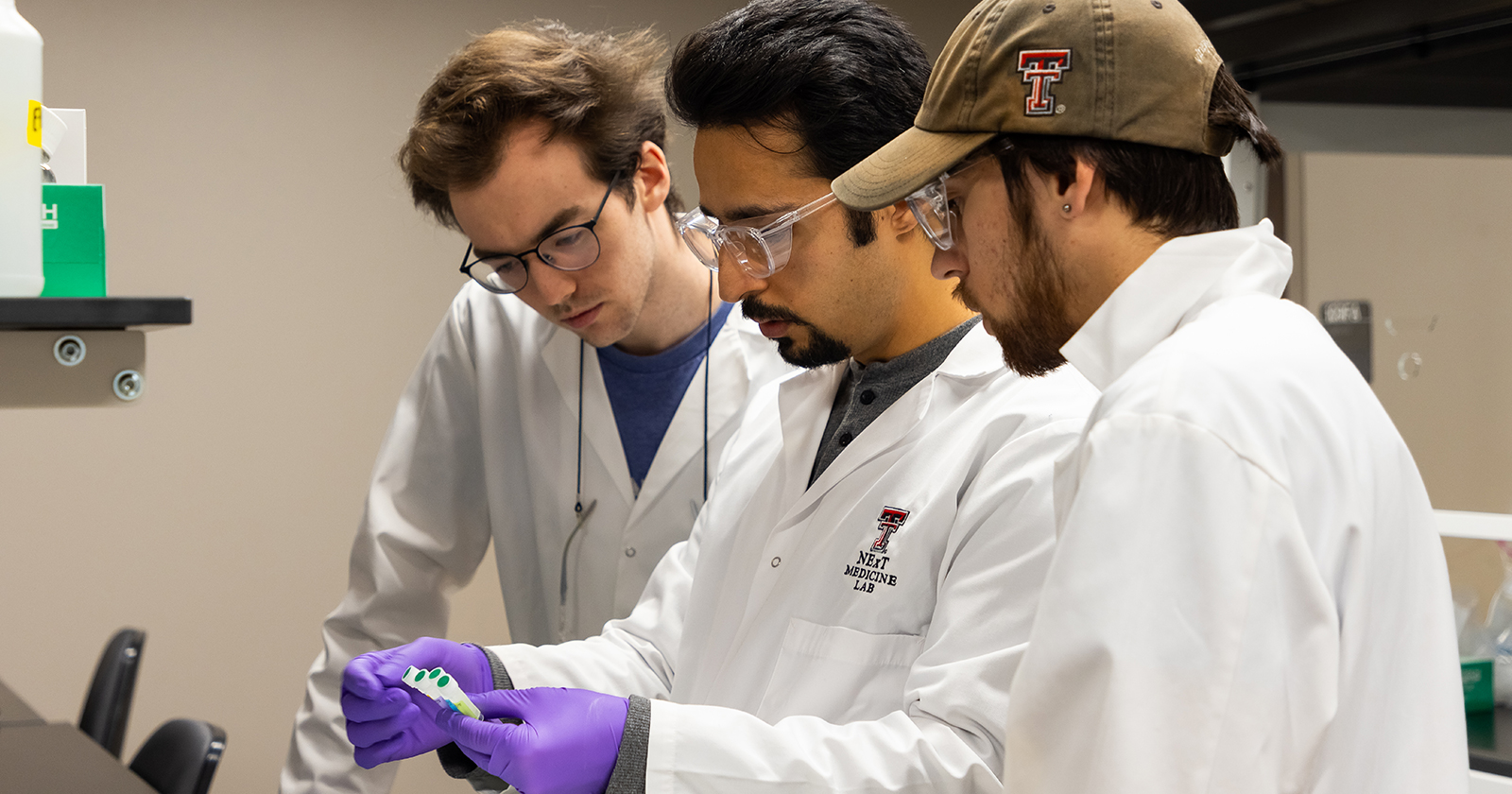 three students in kinesiology lab