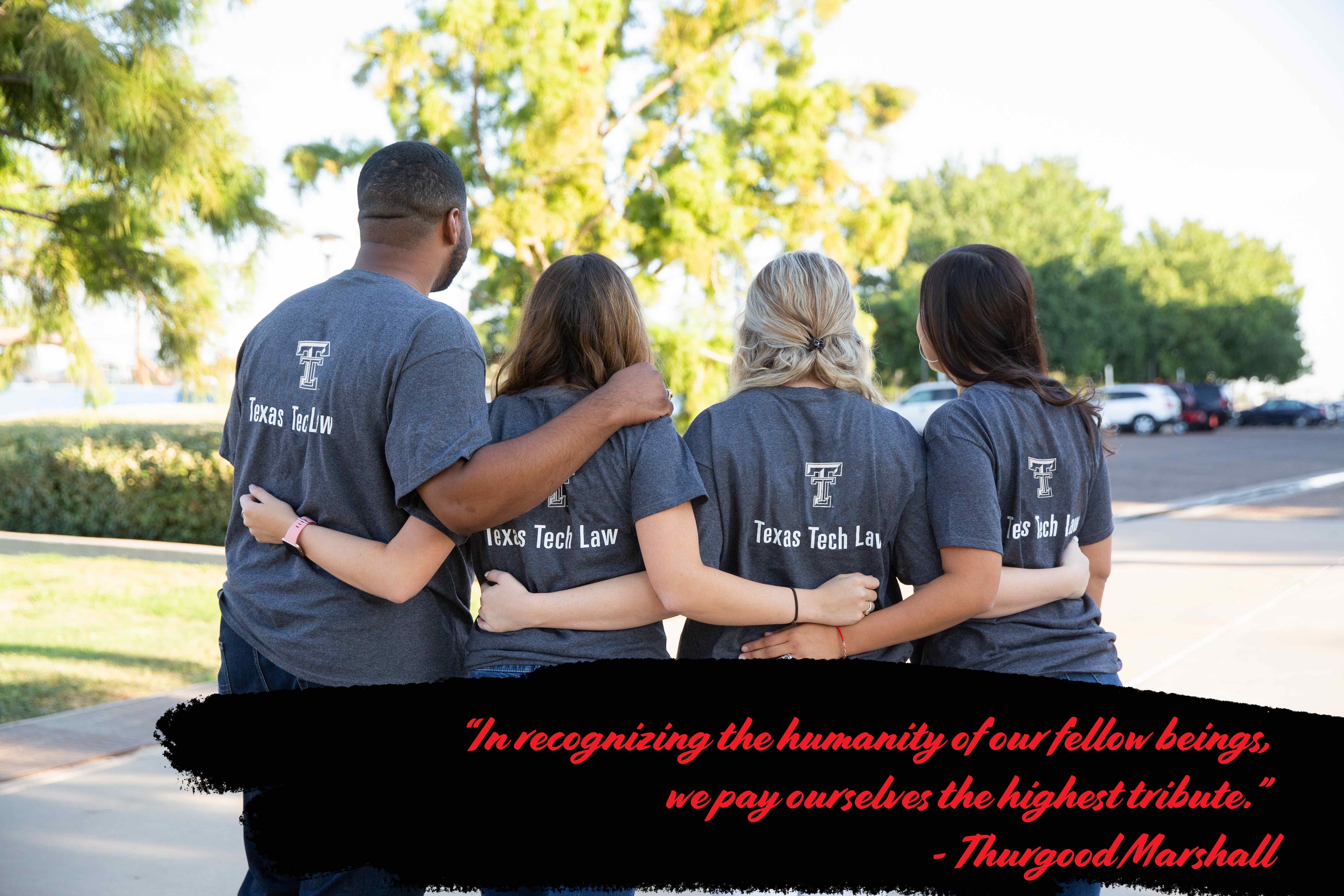 Image of four students standing together with the text: "'In recognizing the humanity of our fellow beings, we pay ourselves the highest tribute.'  - Thurgood Marshall"