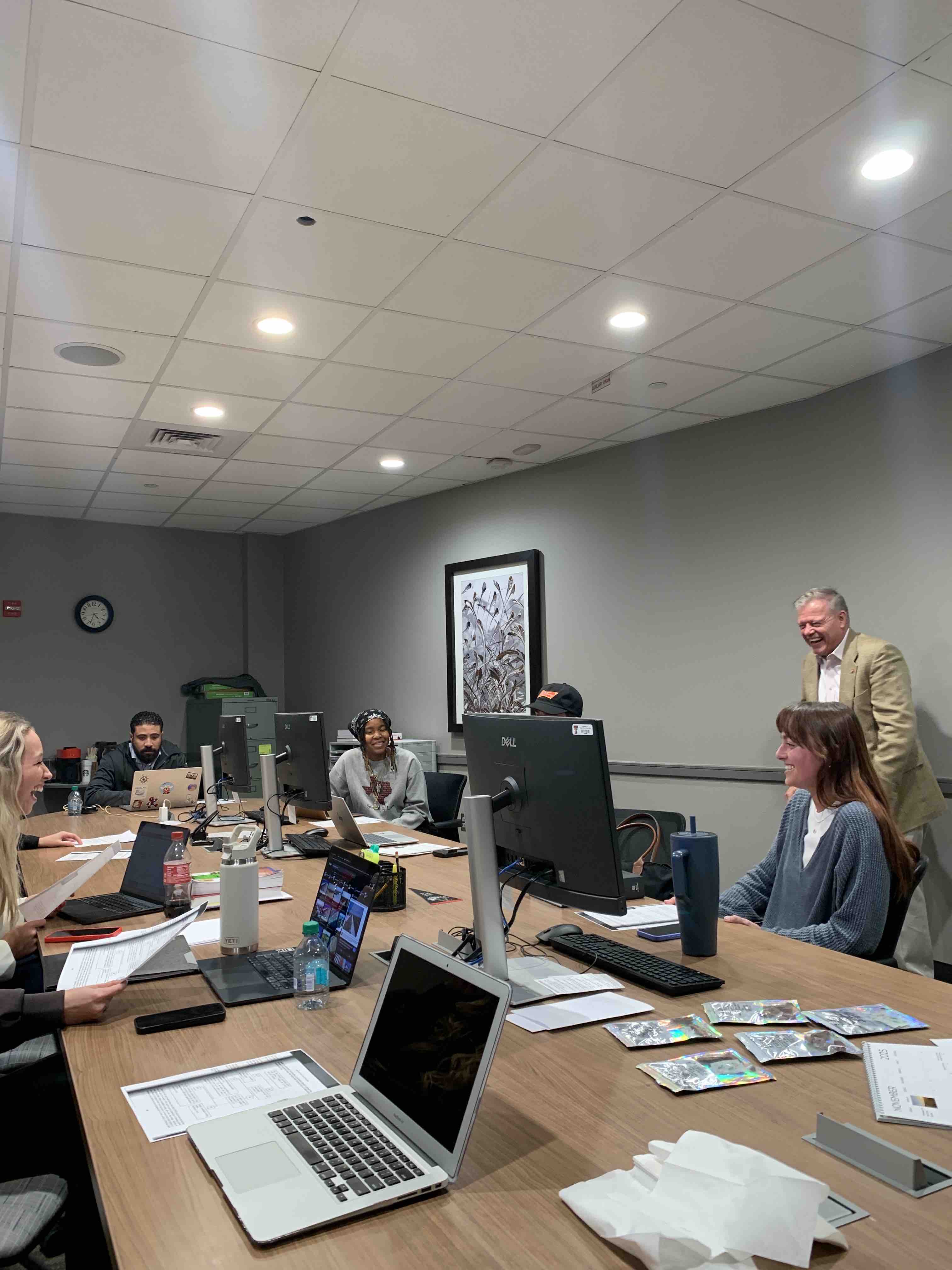 Professor Mark “Max” Maxwell and students in the Texas Tech Law Veterans Law Clinic smiling and laughing together during class.