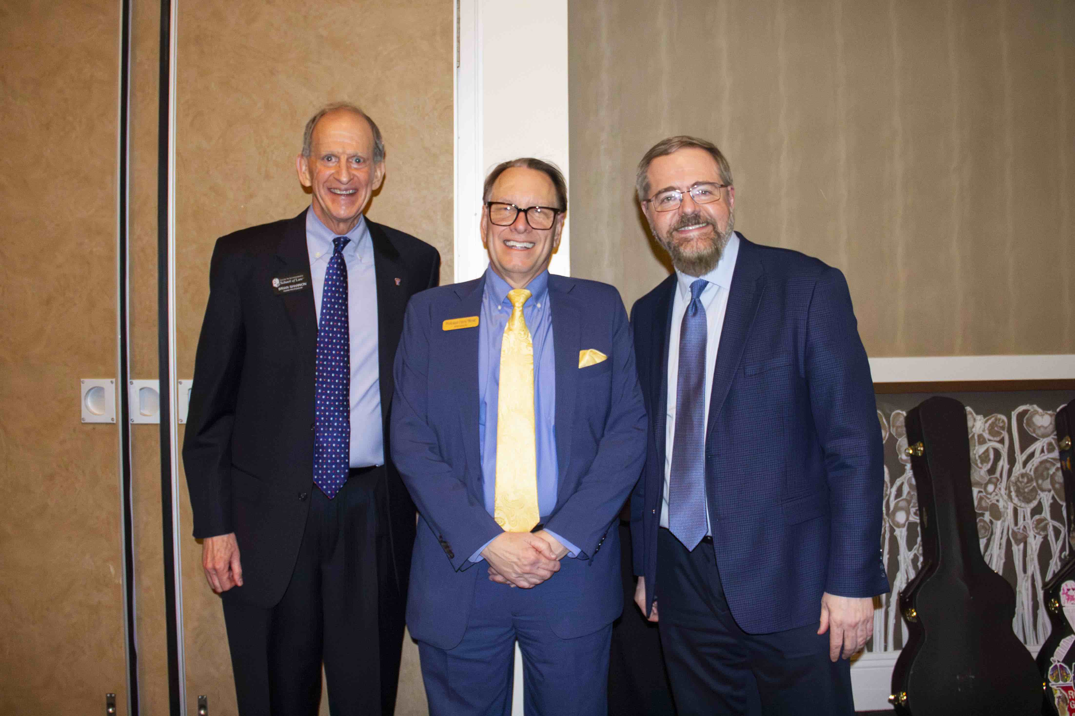 Professors Brian Shannon and Gerry Beyer pose with Dean Jack Wade Nowlin after the scholarship announcement.