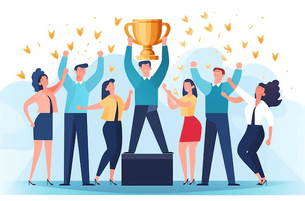 A group of people in an office celebrating as one person holds up a trophy