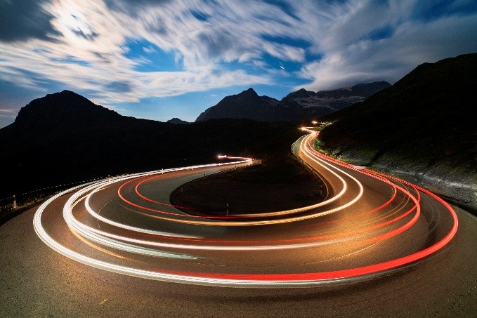 Passing lights on a curve. This demonstrates long exposure photography.