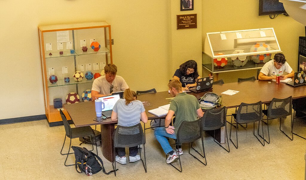 Students studying outside Room 107 in the mathematics foyer