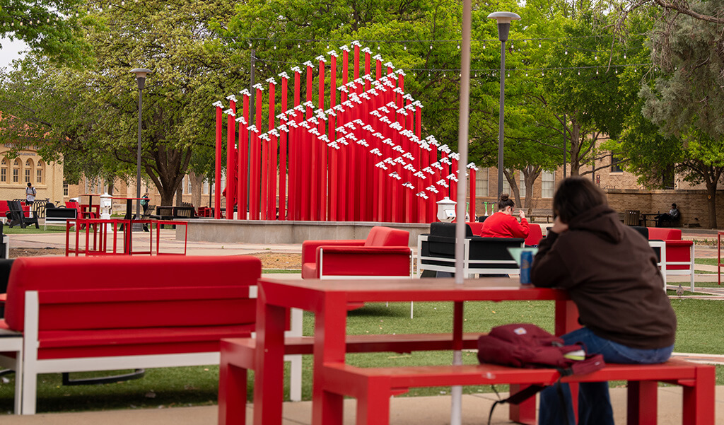 Student studying next to the library in the common space