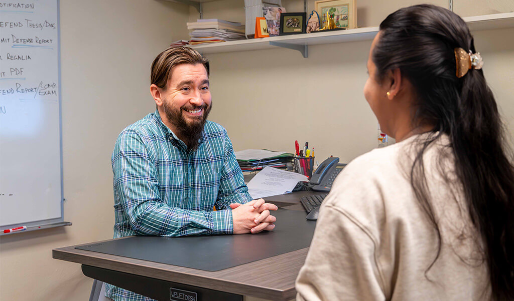 Dr. David Cannon advising a graduate student in his office