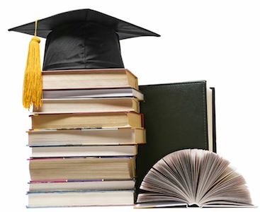 graduation cap on top of books