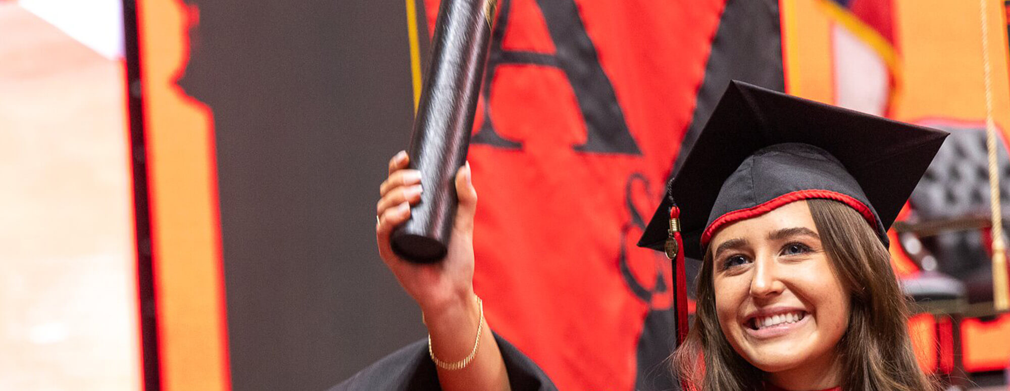 TTU student hold up her diploma during the graduate ceremony