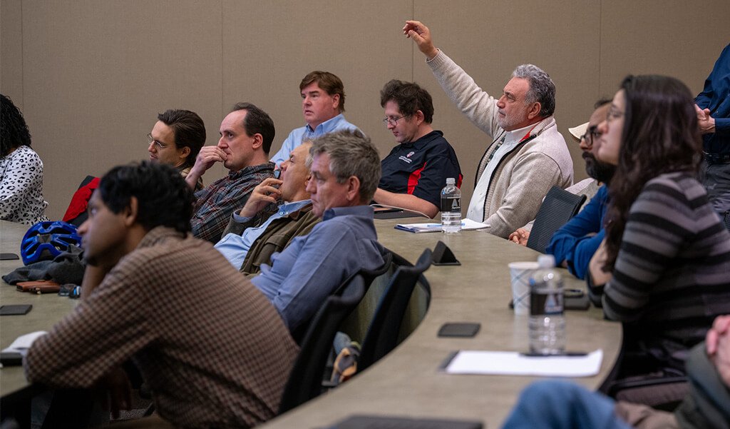 Department of Mathematics and Statistics faculty sitting in a lectern hall