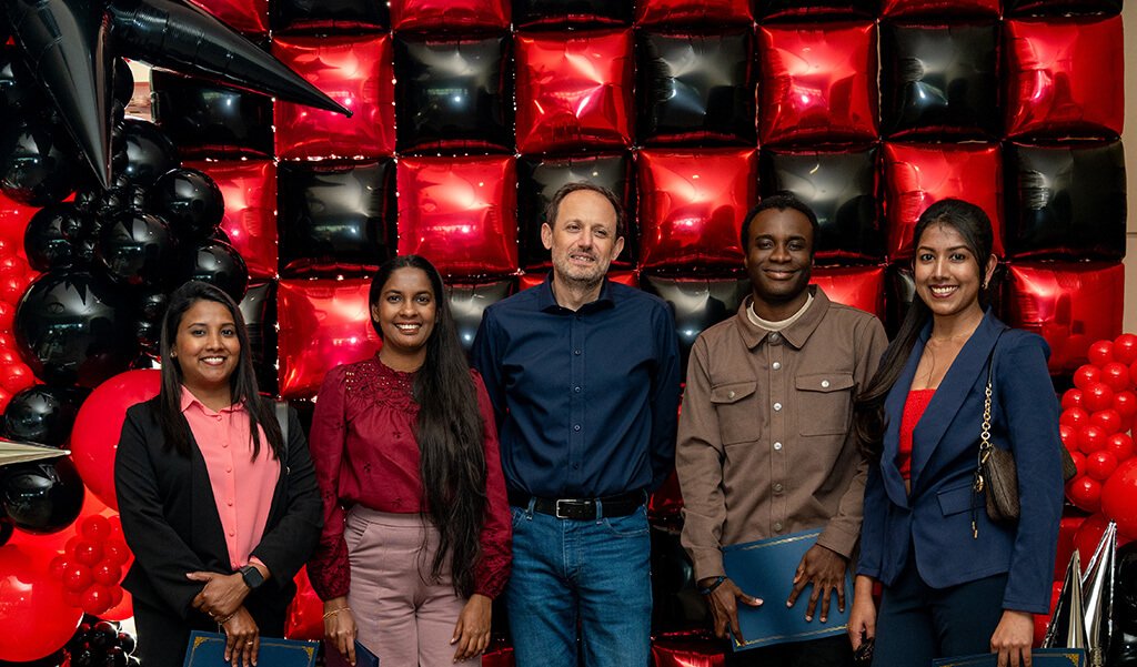 Dr. Eugenio Aulisa and four SIAM students at the Annual Awards Banquet that received awards in 2026