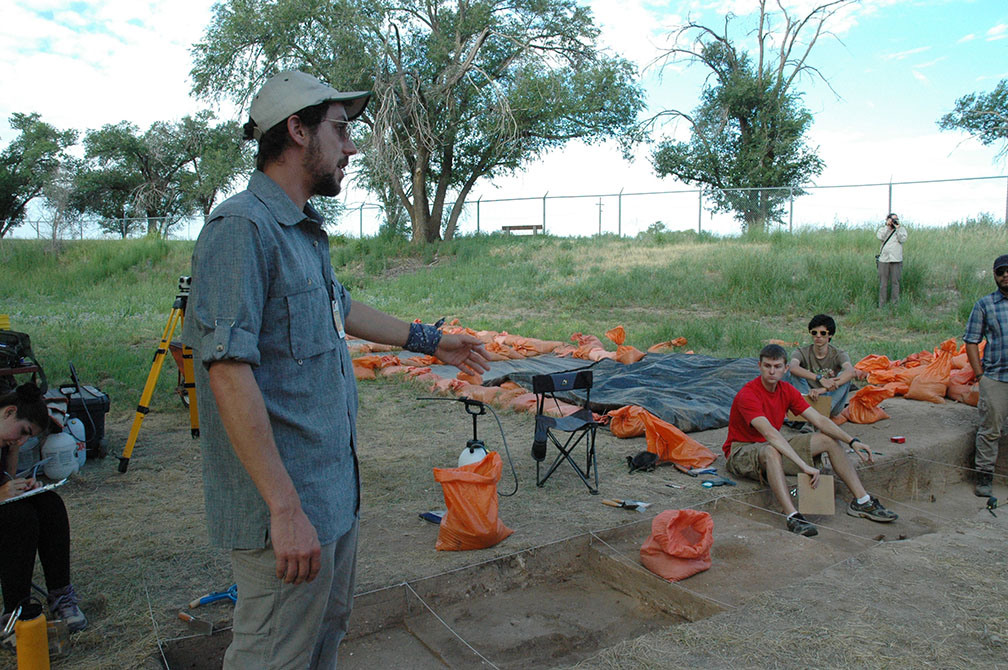 crew member pointing at open excavation units