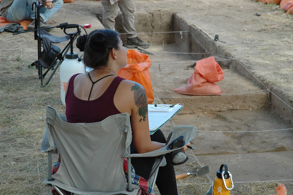 crew member filling out paperwork while excavating