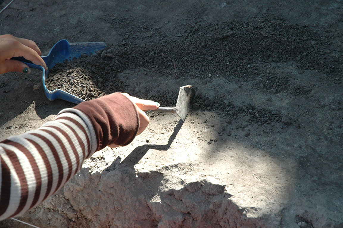 Close up of a trowel in excavation unit